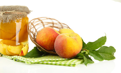 Jar of canned peaches and fresh peaches, isolated on white