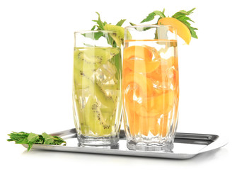 Glasses of fruit drinks with ice cubes isolated on white