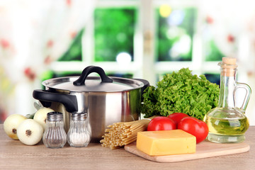 Ingredients for cooking pasta on table in kitchen