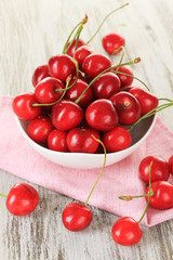 Obraz na płótnie Canvas Cherry berries on wooden table close up