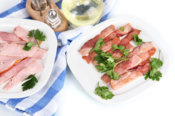 Bacon on plates on napkin isolated on white