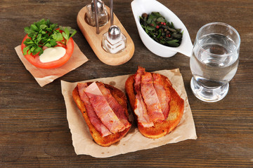 Bacon on toast on wooden table