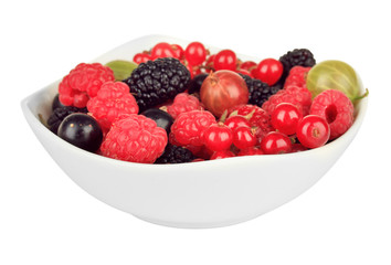 Ripe berries in bowl isolated on white