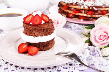 Chocolate cake with strawberry on wooden table close-up