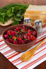 Beet salad in bowl on table close-up