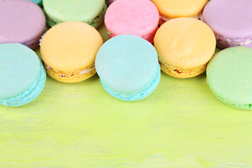Gentle macaroons on wooden table close-up