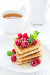 Waffles with raspberry, honey and chocolate.