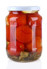 Tasty canned tomatoes in glass jar, isolated on white