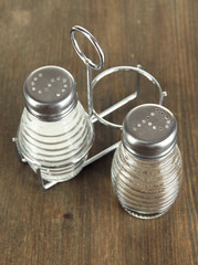 Salt and pepper mills, on wooden background