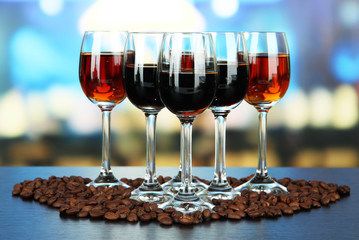 Glasses of liquors, on bright background