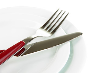 Knife, color plate and fork, isolated on white