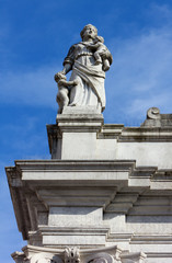 Fototapeta na wymiar Statue at the Top of a Neoclassic Building