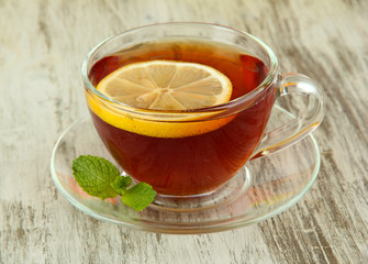 Cup of tea with lemon on table close-up