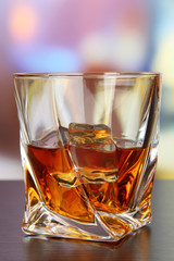 Glass of whiskey, on bright background