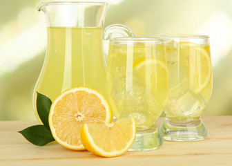 Delicious lemonade on table on light background