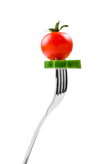 fresh tomato and a slice of cucumber on a fork