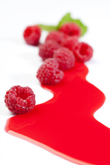 Raspberry juice and raspberry with leaf