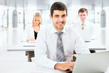 Fototapeta premium Attractive businessman in an office