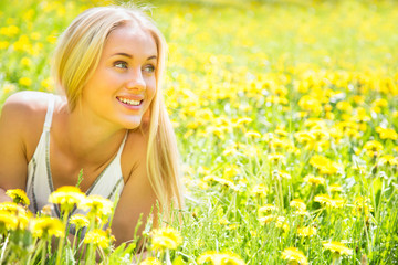 Beautiful young woman among the flowers