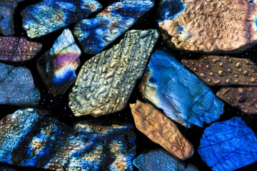 Colorful wet labradorite gem stones.