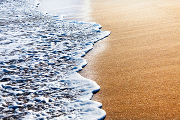 Waves splashing on sandy beach
