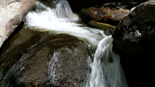 flowing mountain stream with transparent water