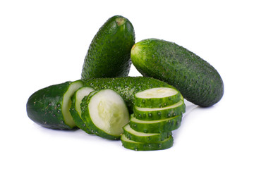 Cucumber and slices isolated over white background