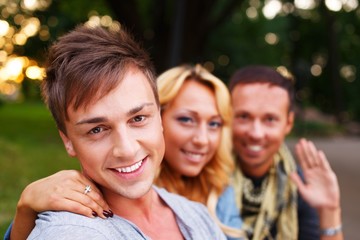 Group of stylish friends  in a park on sunny day