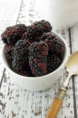 Fresh blackberries on whitewashed table & antique spoon © David Pimborough