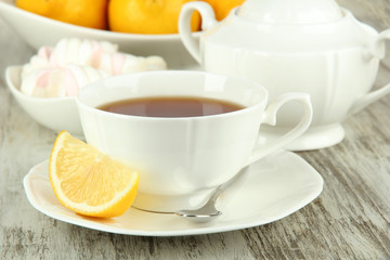 Cup of tea with lemon on table close-up