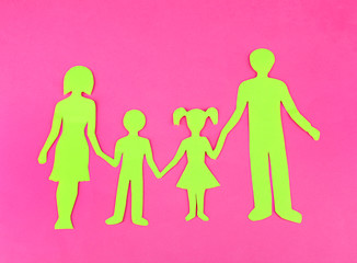 Family from paper on bright background