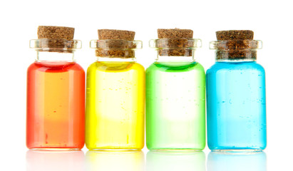 Bottles with colored liquids isolated on white