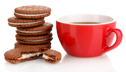 Chocolate cookies with creamy layer and cup of coffe isolated