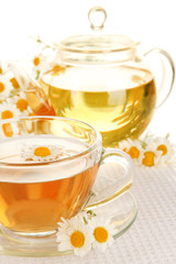 Cup of herbal tea with camomiles close up