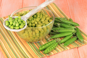 Green peas on wooden background