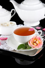 Kettle and cup of tea from tea rose