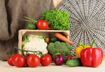 Fresh vegetables in wooden box on table close up
