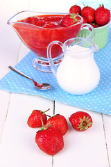 Homemade strawberry jam, on  napkin, on color wooden background
