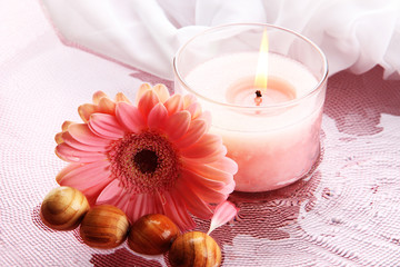Beautiful pink candle with flower in water