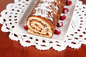 Sweet roll on plate on table close-up