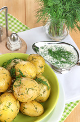 Boiled potatoes on platens on on napkins on wooden table