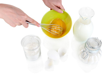 Whisking eggs isolated on white