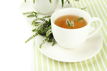 Cup of herbal tea with fresh mint flowers isolated on white