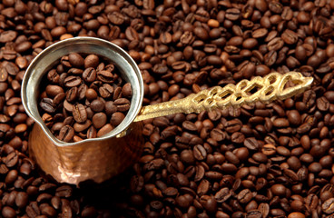Metal turk on coffee beans background
