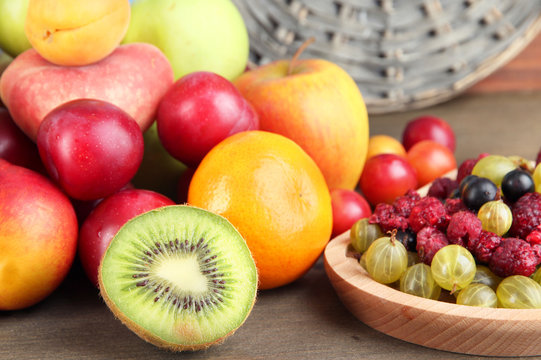 Assortment of juicy fruits, on wooden background