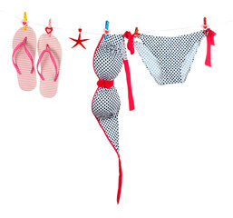 Women's swimsuit and flip-flops hanging