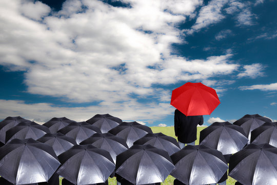 Leader Holding Red Umbrella For Show Different Think