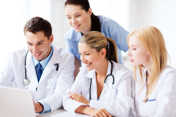 group of doctors looking at tablet pc