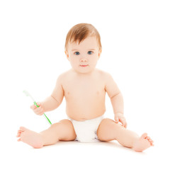 curious baby brushing teeth