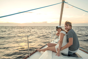 Happy young couple relaxing on a yacht